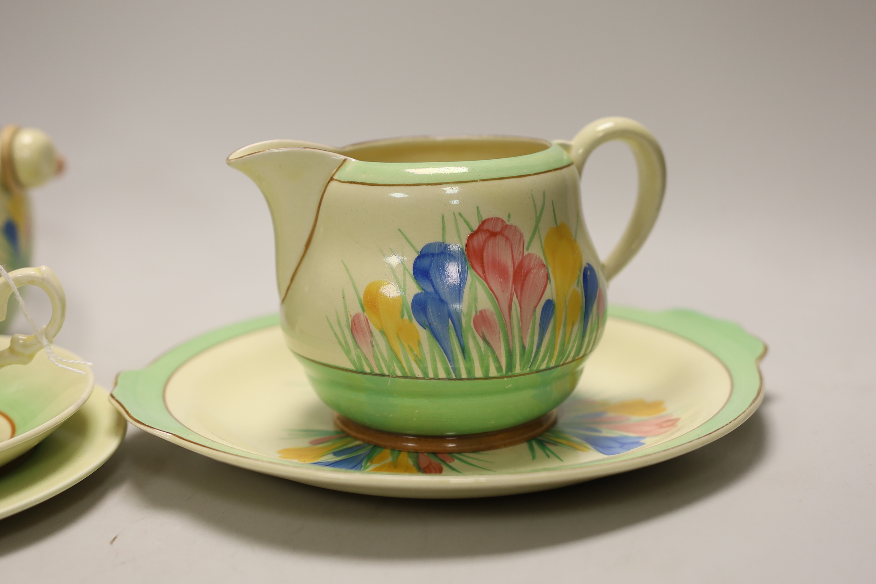 Clarice Cliff ‘Spring Crocus’: a trio, a cake plate, a jug and a biscuit barrel and cover, 17cm high (6)